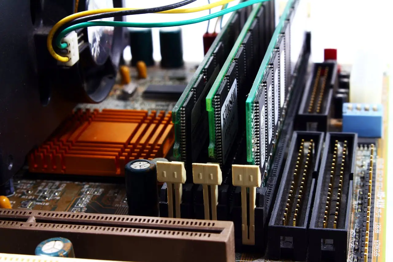 Detailed view of computer motherboard featuring RAM, chipset, and wiring. Detailed view of computer motherboard featuring RAM, chipset, and wiring.